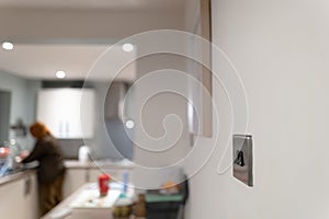 Homeowner seen doing chores by a kitchen sink.