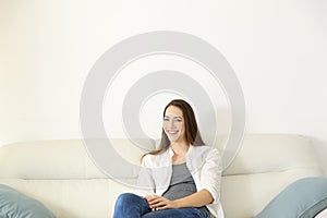 Homeowner sitting on a couch looking at camera photo