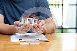 Homeowners selected refinancing of house and checking interest rates and monthly payments.