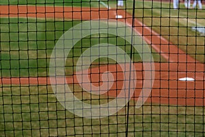 Homeplate at baseball field with focus on net