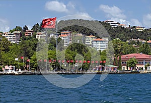 Homes along and turkish flag the Bosporus Turkey