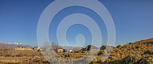 Homes on a hill against moountain and sky in Utah