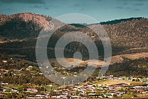 Homes on a lakeside and mountains on the back