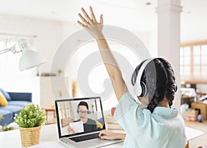 Homeschool Asian little young girl student learning virtual internet online class on table at home. distance online learning