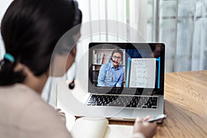 Homeschool Caucasian cute young girl student learning virtual internet online class from school teacher by remote meeting due to c