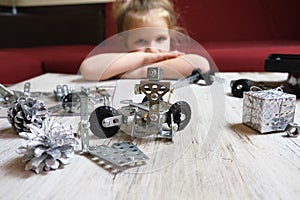 Homeschooling ,child designs,  Screw driver, nuts, wrench, bolts and parts of children`s metallic constructor. children`s metal