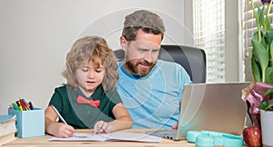 homeschooling and elearning. back to school. father and son use computer at home.
