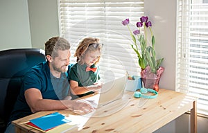 homeschooling and elearning. back to school. happy dad and son in glasses use laptop