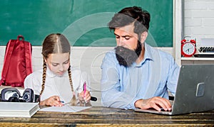 Homeschooling with father. Find buddy to help you study. Private lesson. School teacher and schoolgirl with laptop