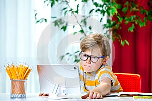 Homeschooling for kid on laptop and tablet computer. Kids work from home. Remote school, online education for young