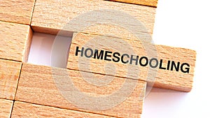 Homeschooling text written on wood block for your desing, Top view, Education concept