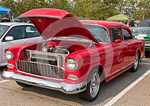 Homestead, Pennsylvania, USA July 21, 2021 A vintage red coupe automobile from the 1950s with it`s hood open