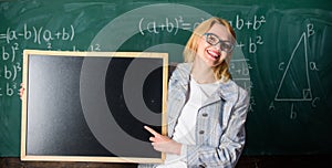 Hometask information. Teacher show school information. Teacher smart smiling woman hold blackboard blank advertisement