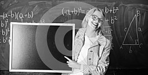 Hometask information. Teacher show school information. Teacher smart smiling woman hold blackboard blank advertisement photo