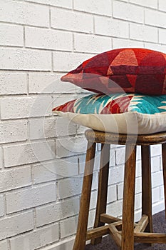 Homewares decorator cushions on a wooden stool photo