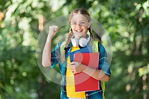 Homework done. Happy kid celebrate back to school. Little child hold books. Homework assignment. Afterschool activities