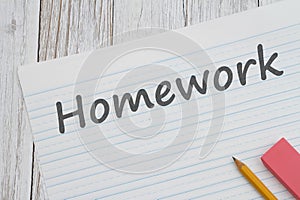Homework message on ruled lined paper with pencil for school photo