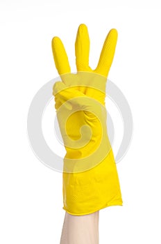 Homework, washing and cleaning of the theme: man's hand holding a yellow and wears rubber gloves for cleaning isolated on white ba