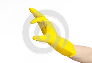 Homework, washing and cleaning of the theme: man's hand holding a yellow and wears rubber gloves for cleaning isolated on white ba