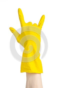 Homework, washing and cleaning of the theme: man's hand holding a yellow and wears rubber gloves for cleaning isolated on white ba