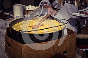 Hominy prepared in a caldron on fire