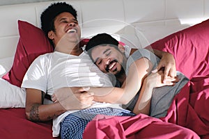 Homosexual Couple Hugging and Relaxing In Bed