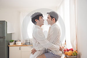 Homosexual couple prepairing breakfast in kitchen