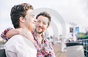 Homosexual couple sitting in Santa monica pier on a bench