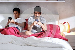 Homosexual Men With Smartphones Ignoring Each Other