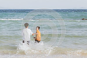 Homosexual portrait young asian couple running with cheerful together on beach in summer