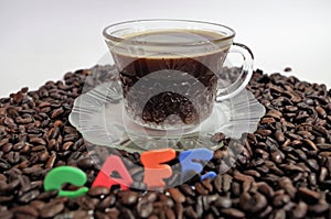 Honduras coffe beans on white surface with a cup of fresh brewed coffe name label 12