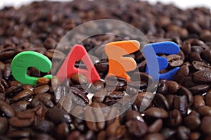 Honduras coffe beans on white surface with a cup of fresh brewed coffe name label 13