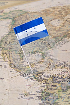 Honduras flag pin on a world map