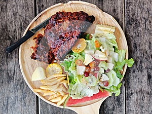 Hone made rib grill steak with french fries and salad.