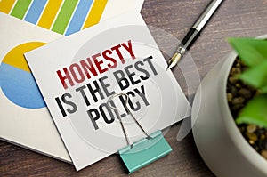 honesty is the best policy words on notepad and charts
