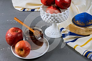 Honey and apples on jewish holiday Rosh Hashanah torah book, kippah a yamolka talit