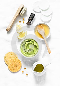 Honey and avocado face mask on light background, top view. Beauty, youth, skin care concept.