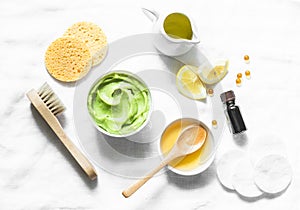 Honey and avocado face mask on light background, top view. Beauty, youth, skin care concept.