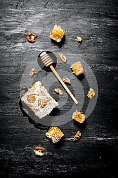 Honey background. Natural honey comb and a wooden spoon .