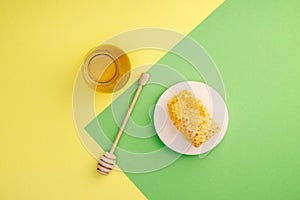 Honey background. Sweet honey in a glass jar and a honey spoon.