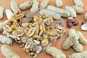 Honey bar with peanuts almonds and hazelnuts surrounded by roast