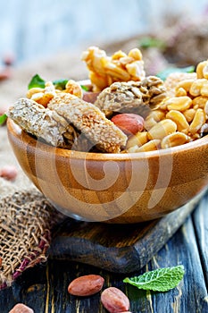 Honey bars with peanuts, sesame seeds and sunflower seeds in a w