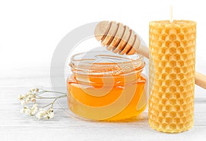 Honey, beeswax candle, honey dipper.