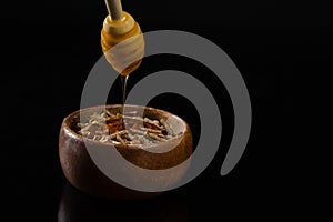 Honey being poured into cereal bran sticks