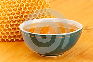 Honey in bowl with honeycomb and cinnamon