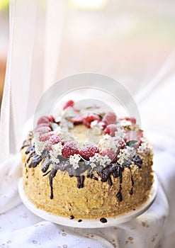 Honey cake, decorated with berries and chocolate. sweet family dinner. holiday cake. on the balcony breakfast,