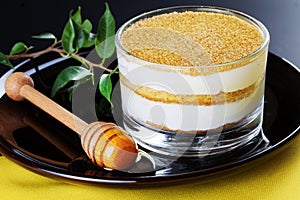 Honey cake in glass closeup on a black background