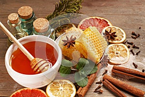 Honey, cinnamon and dried fruits on a wooden table. Healthy eating