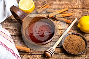 Honey and cinnamon on a wooden table