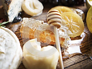 Honey comb and honey stick on the wooden table